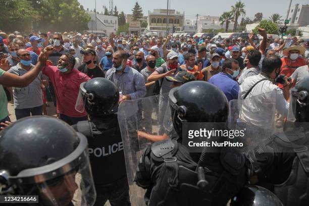 Supporters of the Islamist party Ennahdha clash with riot police during a sit-in protest led by the Tunisian Parliament Speaker Rached Ghannouchi, in...