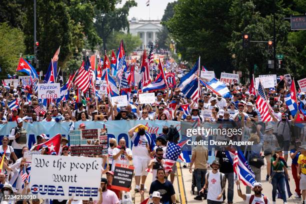 Cuban activists and supporters march from the White House to the Cuban Embassy on 16th Street during a Cuban freedom rally on July 26, 2021 in...