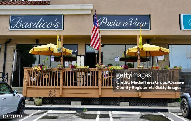 Signs at Basilicos Pasta e vino encourage people without the COVID-19 vaccine to dine at the restaurant in Huntington Beach, CA, on Monday, July 26,...