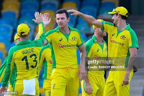 Josh Hazlewood and Mitchell Starc of Australia celebrate the dismissal of Alzarri Joseph of West Indies during the 3rd and final ODI between West...