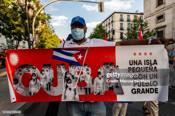 Protesters carrying a placard reading 'a small island with a great people' during a demonstration against the US economic embargo on Cuba, coinciding...