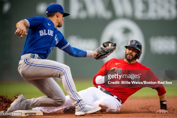 Martinez of the Boston Red Sox slides into third base as he beats the tag of Cavan Biggio of the Toronto Blue Jays during the first inning of a game...