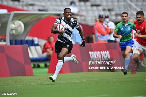 Fiji's Jiuta Wainiqolo runs for the try in the men's pool B rugby sevens match between Fiji and Britain during the Tokyo 2020 Olympic Games at the...