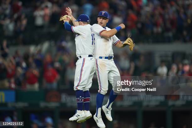 Brock Holt and Nathaniel Lowe of the Texas Rangers celebrate after the game between the Houston Astros and the Texas Rangers at Globe Life Field on...