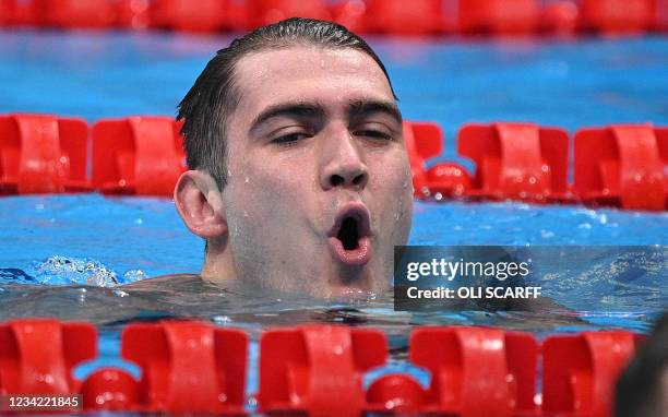 Russia's Kliment Kolesnikov reacts after taking second place in the final of the men's 100m backstroke swimming event during the Tokyo 2020 Olympic...