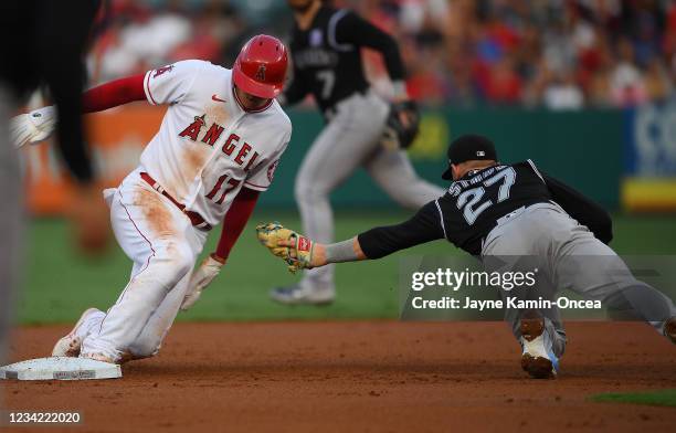 Shohei Ohtani of the Los Angeles Angels beats the tag by Trevor Story of the Colorado Rockies for a stolen base in the first inning of the game at...