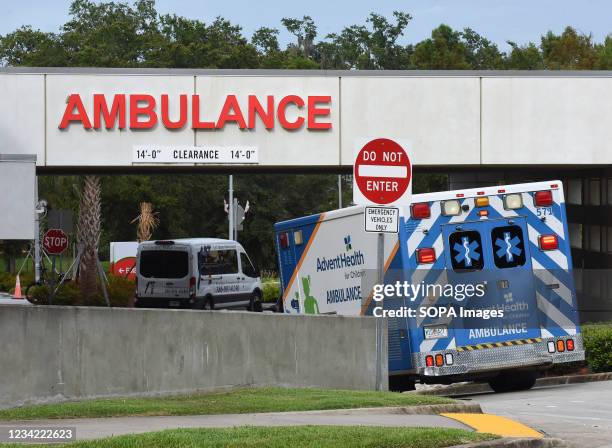 An ambulance arrives at the emergency department at AdventHealth hospital in Orlando on the day that hospital officials reported they were elevating...