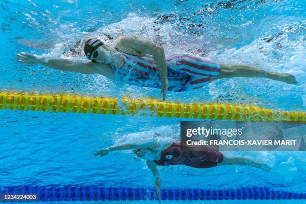 An underwater view shows USA's Kathleen Ledecky and Canada's Summer McIntosh competing in a semi-final of the women's 200m freestyle swimming event...