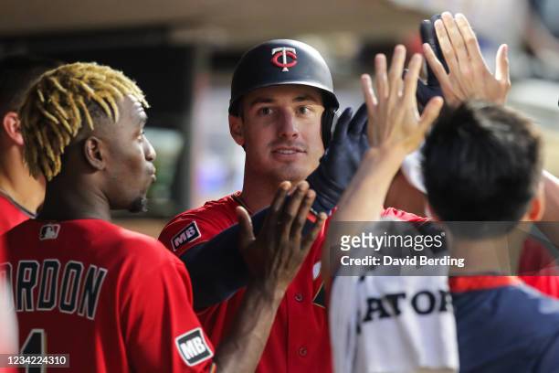 Brent Rooker of the Minnesota Twins celebrates with teammates after hitting a solo home run against the Detroit Tigers in the sixth inning of the...