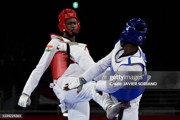 Ivory Coast's Seydou Gbane and Niger's Abdoul Razak Issoufou Alfaga compete in the taekwondo men's +80kg elimination round bout during the Tokyo 2020...