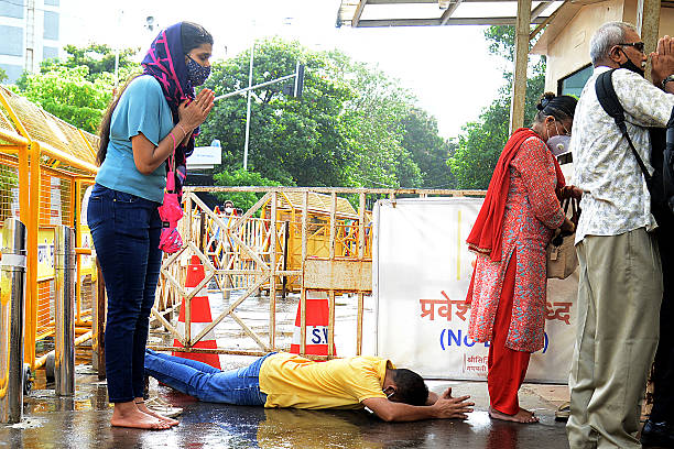 Devotees offer prayers outside the closed Siddhivinayak Ganapati Temple during the auspicious day of Angarki Sankashti Chaturthi amid Covid-19...