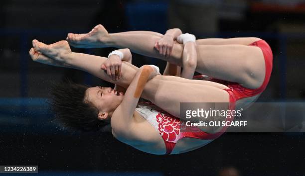 China's Chen Yuxi and China's Zhang Jiaqi compete in the women's synchronised 10m platform diving final event during the Tokyo 2020 Olympic Games at...