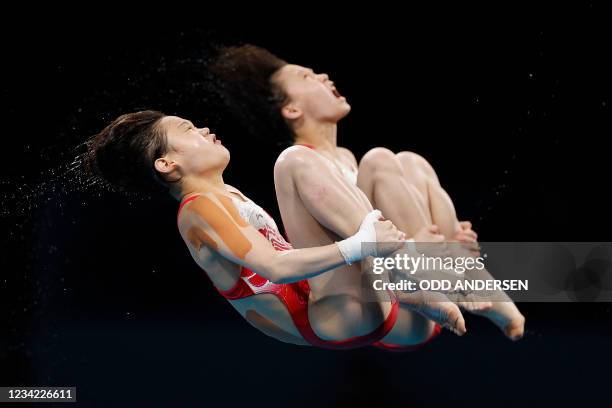 China's Zhang Jiaqi and China's Chen Yuxi compete in the women's synchronised 10m platform diving final event during the Tokyo 2020 Olympic Games at...