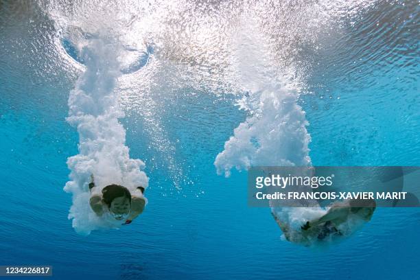 An underwater view shows Japan's Matsuri Arai and Japan's Minami Itahashi competing in the women's synchronised 10m platform diving final event...