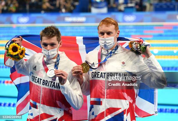Silver medalist Duncan Scott of Team Great Britain and gold medalist Tom Dean of Team Great Britain pose with their medals for the Men's 200m...