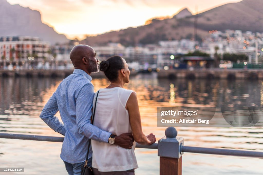 Couple looking at sunset at Cape Town waterfront