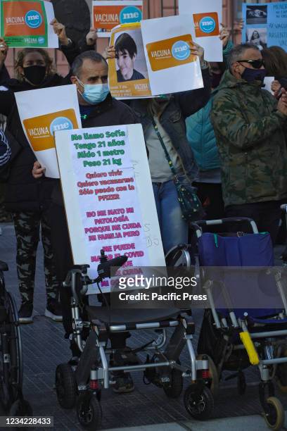 Father holding up a sign saying his daughter can only get vaccinated with the Pfizer vaccine. Parents of underage children with different...
