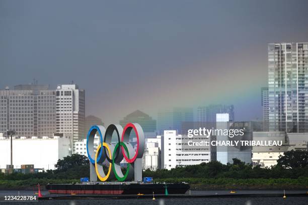 Rainbow is seen above the Olympic rings during the women's individual triathlon competition during the Tokyo 2020 Olympic Games at the Odaiba Marine...