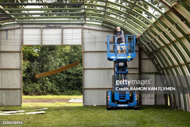 An operator disassembles the Lowlands festival site's premises in Biddinghuizen on July 27 2021. - The organization had already started construction...