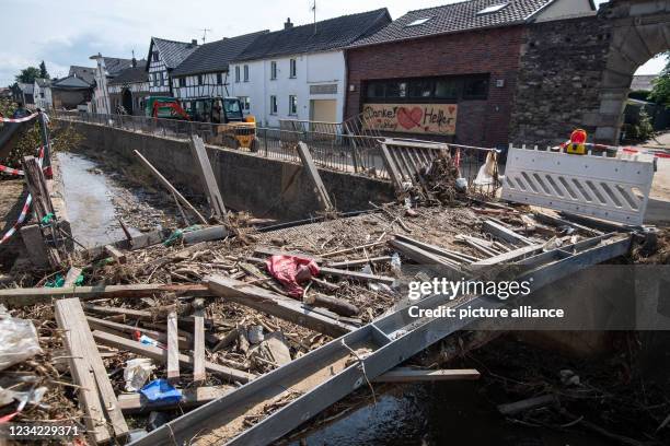 July 2021, North Rhine-Westphalia, Swisttal: Destroyed is this bridge over the Orbach. After last week's flood disaster, clean-up work is underway in...