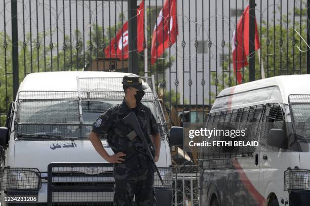 Tunisian police stand guard outside the parliament in Tunis on July 27, 2021. - Tunisia, the birthplace of the Arab Spring revolts a decade ago and...