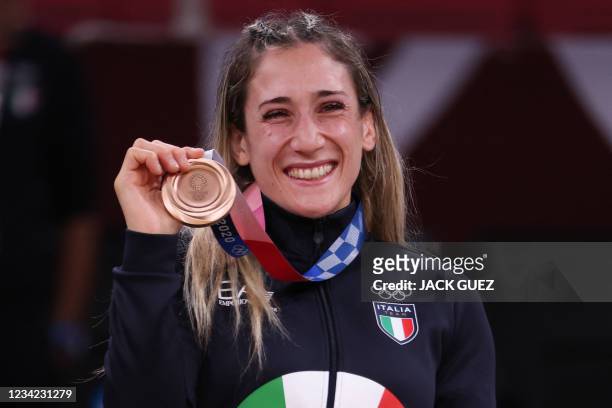 Bronze medallist Italy's Maria Centracchio celebrates during the medal ceremony for the judo women's -63kg contest during the Tokyo 2020 Olympic...