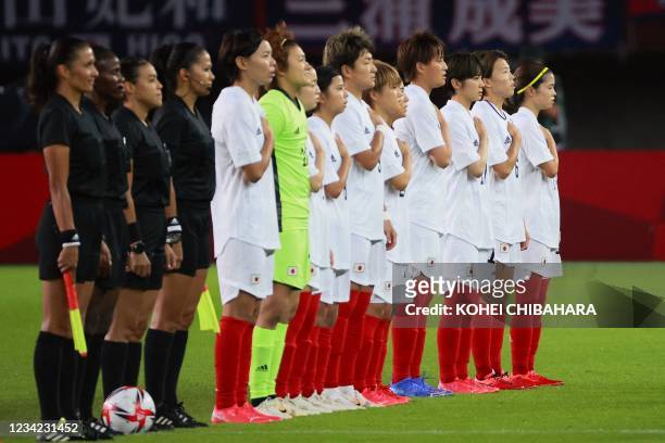Japan players sing their national anthem before the Tokyo 2020 Olympic Games women's group E first round football match between Chile and Japan at...