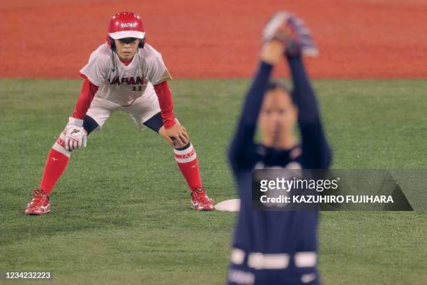 Japan's Eri Yamada watches USA's starting pitcher Catherine Osterman on the second base during the first inning of the Tokyo 2020 Olympic Games...