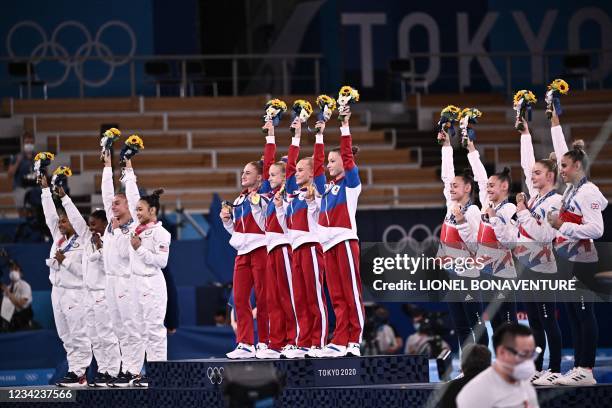 Team USA , team Russia and team Great Britain pose during the podium ceremony of the artistic gymnastics women's team final during the Tokyo 2020...