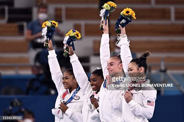 S Jordan Chiles, USA's Simone Biles, USA's Grace Mc Callum and USA's Sunisa Lee celebrate winning the silver medal during the podium ceremony of the...