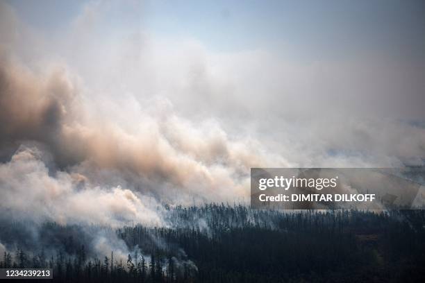 This aerial picture taken from an airplane on July 27 shows the smoke rising from a forest fire outside the village of Berdigestyakh, in the republic...