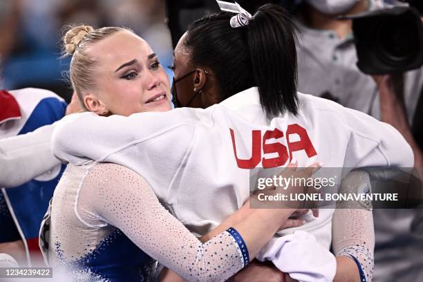 Russia's Angelina Melnikova is congratulated by USA's Simone Biles as Russia wins the artistic gymnastics women's team final during the Tokyo 2020...