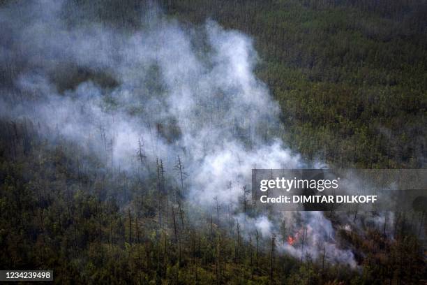 This aerial picture taken from an airplane on July 27 shows the smoke rising from a forest fire outside the village of Berdigestyakh, in the republic...