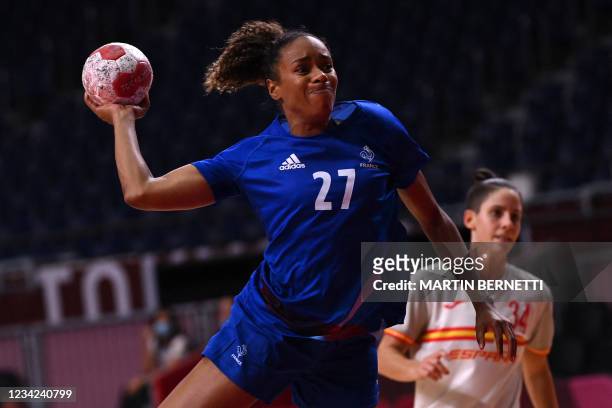 France's left back Estelle Nze Minko shoots during the women's preliminary round group B handball match between France and Spain of the Tokyo 2020...
