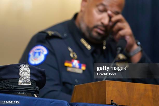 The cover of Washington Metropolitan Police Department officer Daniel Hodges sits on the witness table as U.S. Capitol Police Sgt. Harry Dunn wipes...
