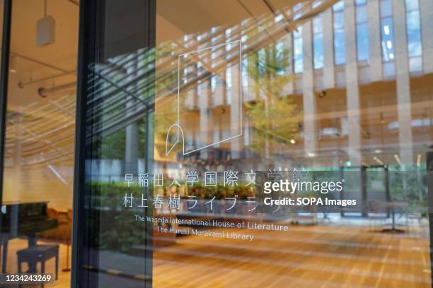 Signs seen at the entrance window of the library saying "The Waseda International House of Literature / The Haruki Murakami Library". The University...