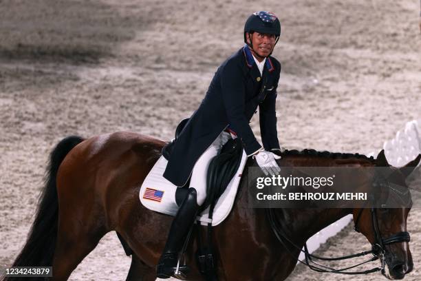 Steffen Peters of the US riding Suppenkasper looks at the scoreboard after competing in the dressage grand prix special team competition during the...