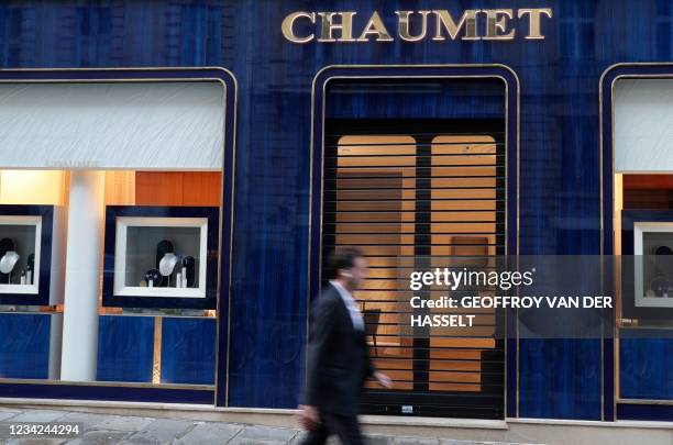 Passer-by walks past a Chaumet jewellery store located close to the Champs-Elysee avenue in central Paris, on July 27, 2021. - The Chaumet jewellery...