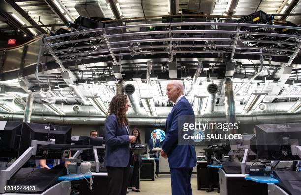 President Joe Biden speaks with the Director of the National Counterterrorism Center Christine Abizaid , as he tours the Center's Watch Floor at the...