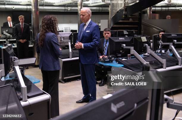 President Joe Biden speaks with the Director of the National Counterterrorism Center Christine Abizaid, as he tours the Center's Watch Floor at the...