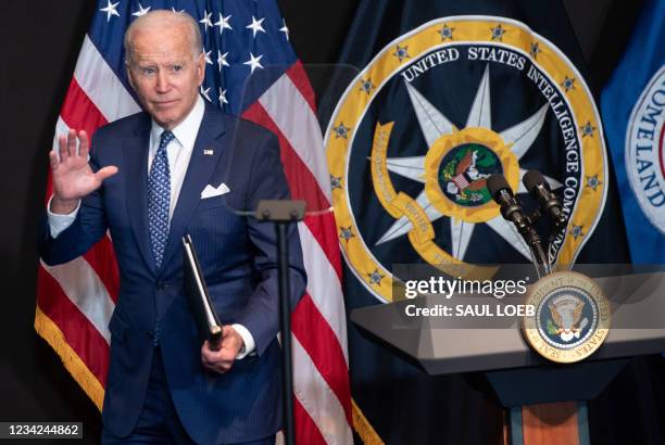 President Joe Biden leaves after addressing the Intelligence Community workforce and its leadership while on a tour at the Office of the Director of...