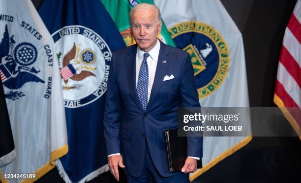 President Joe Biden leaves after addressing the Intelligence Community workforce and its leadership while on a tour at the Office of the Director of...