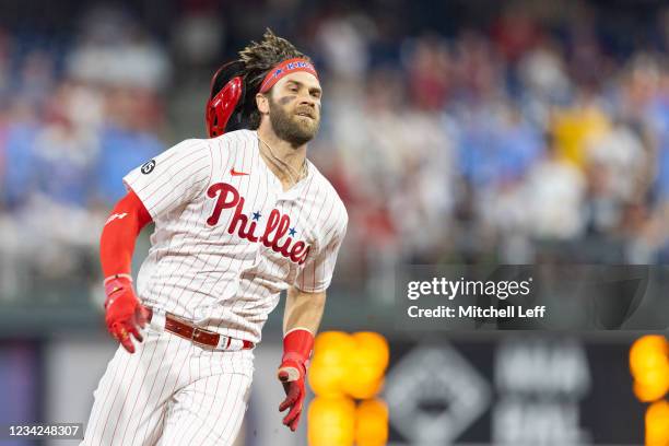 Bryce Harper of the Philadelphia Phillies runs to third base on his way to an inside the park home run in the bottom of the fifth inning against the...