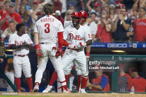 Bryce Harper of the Philadelphia Phillies celebrates with Andrew McCutchen after hitting an inside-the-park home run in the bottom of the fifth...