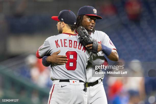 Carter Kieboom of the Washington Nationals hugs Josh Bell after the game against the Philadelphia Phillies at Citizens Bank Park on July 27, 2021 in...