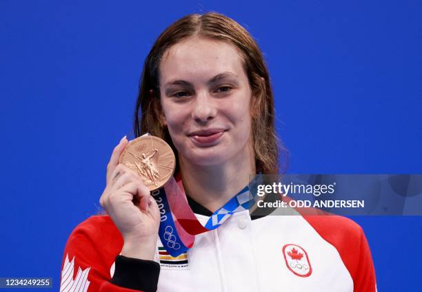 Bronze medallist Canada's Penny Oleksiak poses with her medal on the podium after the final of the women's 200m freestyle swimming event during the...