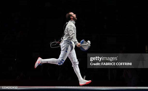 Italy's Luca Curatoli celebrates after scoring the final point against Hungary's Aron Szilagyi compete against in the men's sabre team semifinal bout...