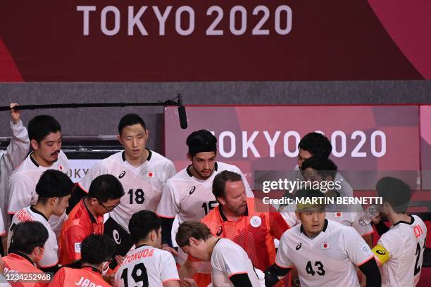 Japan's Icelandic coach Dagur Sigurdsson gives instructrions to his players during the men's preliminary round group B handball match between Japan...