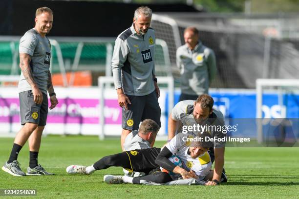 Head coach Marco Rose of Borussia Dortmund, assistant coach Rene Maric of Borussia Dortmund and goalkeeper Gregor Kobel of Borussia Dortmund laughs...