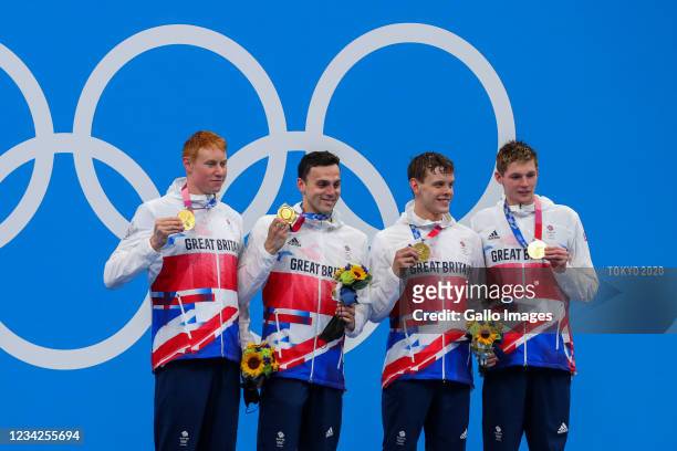 Duncan Scott, Tom Dean, James Guy and Matthew Richards of Great Britain on the winners podium with their gold medals after winning the mens 4x200m...
